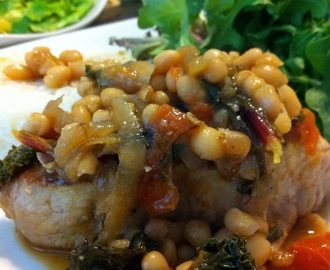 Braised Pork Chops with Smoked Beef Sausage, White Beans, Beet Greens and Kale with a Wine Dijon Reduction