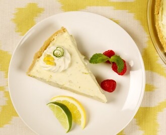 Lemon Lime Refrigerator Cheesecake
	            
crushed shortbread cookies
butter
pkg cream cheese
whipping cream
sweetened condensed milk
finely grated lemon rind
finely grated lime rind
lime juice
granulated sugar
lemon rind
lime rind