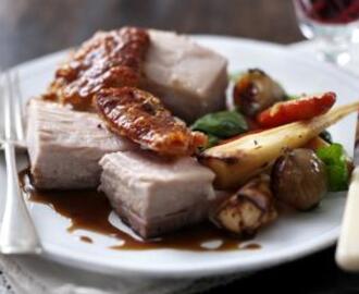 Roast belly of pork with root vegetables
