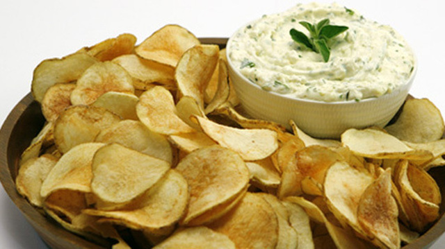 Saratoga Chips with Herbed Feta Dip
	            
baking potatoes
oil for deep-frying
salt
finely crumbled feta cheese
each light sour cream and light mayonnaise
minced fresh parsley
minced fresh oregano
small clove garlic
hot pepper sauce