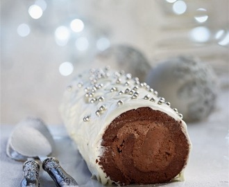 White Christmas chocolate log with chestnut filling, covered with white chocolate and cream cheese frosting