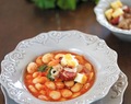 Spicy giant beans soup served with country-style sausages
