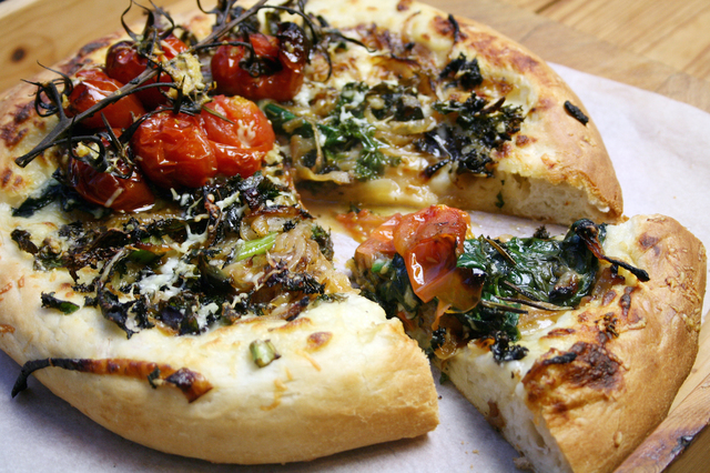 olive oil white sauce pizza with caramelised onions, kale, spinach and tomato