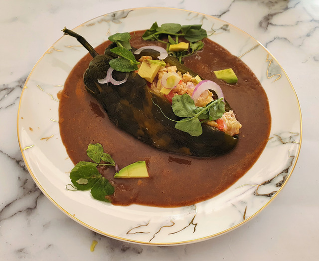 Poblanos stuffed with Mexican eggs with black bean sauce