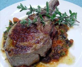 Veal cutlets with olive, tomato and anchovy sauce