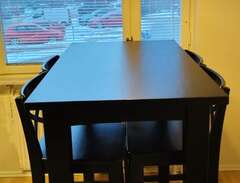 Hög matbord och fyra stolar